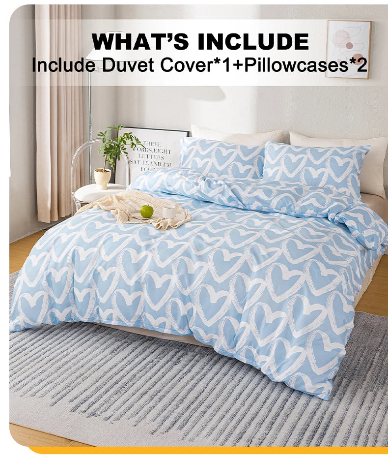 A light blue heart print duvet cover set with two pillowcases displayed on a bed with a neutral gray rug.