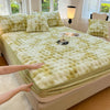 A luxury faux fur fitted sheet and pillowcase set in pale lime green color displayed on a bed.