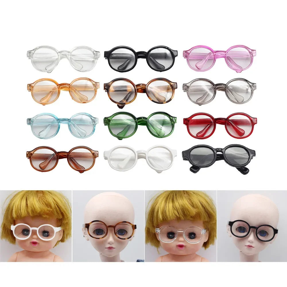 A collection of transparent plastic sunglasses for dolls in various colors and styles.