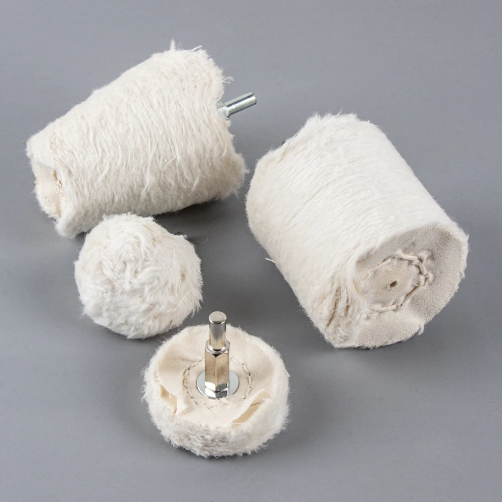 A set of white cotton polishing buffing wheels with metal shafts for use with a drill.