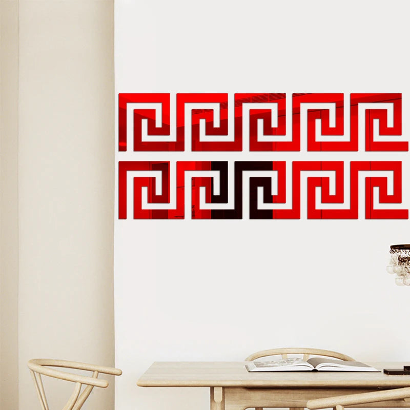 Red and black geometric maze pattern wall stickers on a white wall.