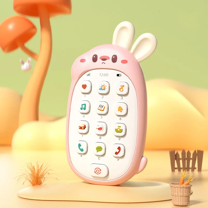 A pink rabbit-shaped baby music phone toy with a teether resting on a light yellow surface.