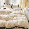 White polka dot bedding set with a duvet cover and pillows displayed on a bed.