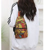 A person is wearing a colorful leaf print sling crossbody bag with multiple pockets on a light gray sweatshirt.