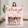 A pink microfiber fleece throw blanket featuring illustrations of various characters.