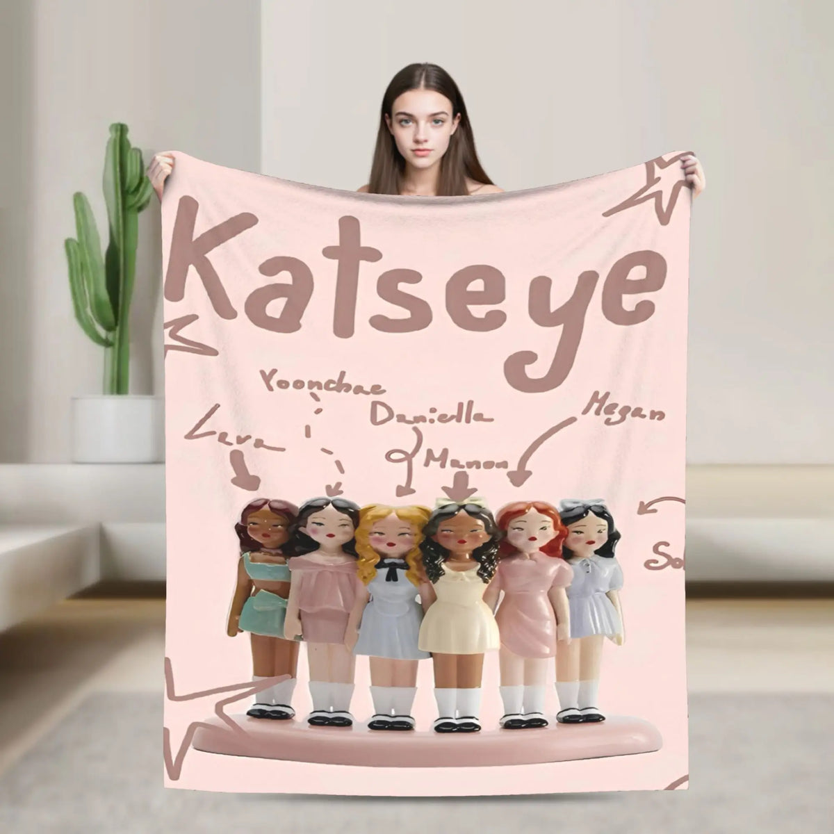 A pink microfiber fleece throw blanket featuring illustrations of various characters.