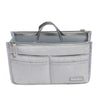 A gray purse organizer insert with multiple compartments and a carrying handle.