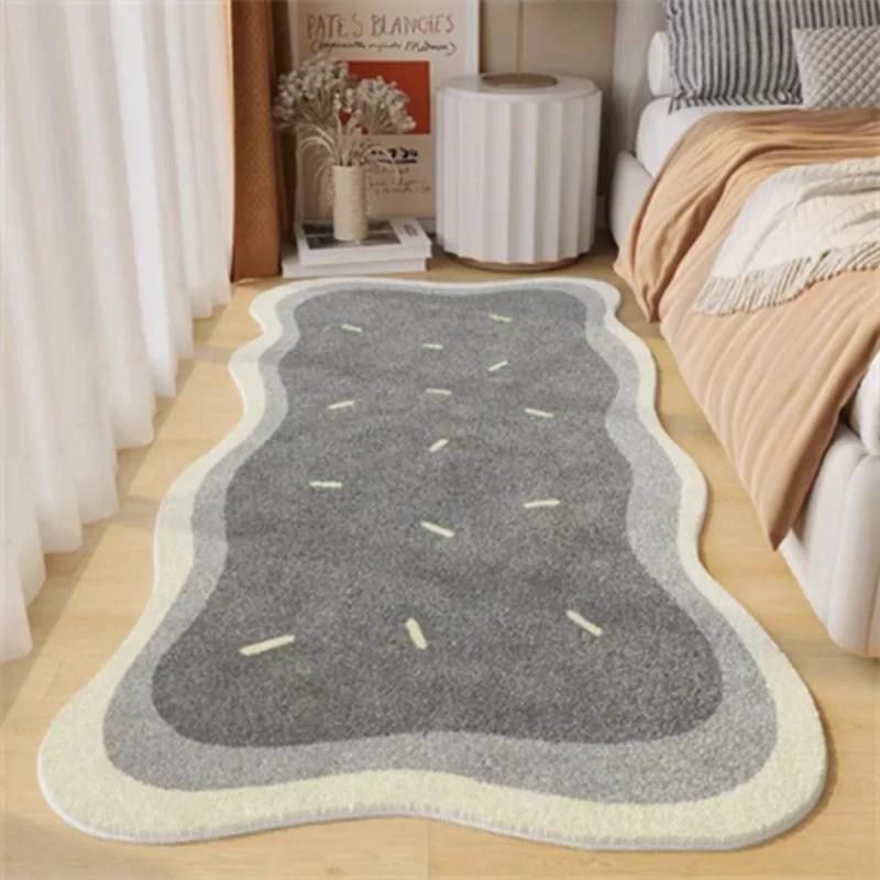 A gray and beige plush non-slip decorative area rug placed on a light wood floor.