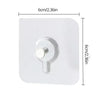 A white adhesive hook with a round pull tab is shown against a white background.