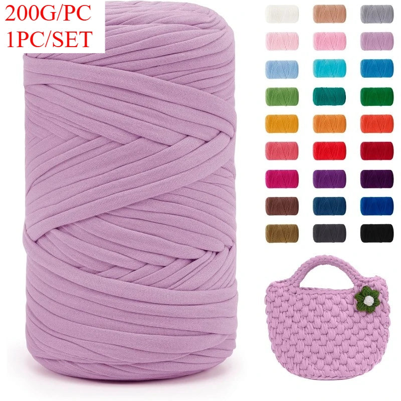 A skein of thick purple yarn is shown next to a crocheted bag.