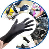 A close-up view of black disposable nitrile gloves being used for handling food and machinery.