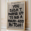 A framed print featuring a large black text quote on a vintage newspaper background.