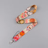 A patterned lanyard featuring celestial sun and moon designs for holding an ID badge.