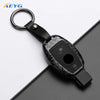 A black slim carbon fiber car key cover with a metal keyring attached.