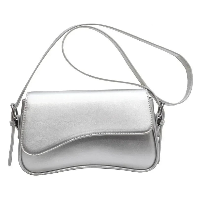 Silver vintage leather crossbody bag with a smooth flap closure