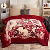 A deep red weighted plush blanket featuring a large floral pattern on the front and a lighter design on the reverse.