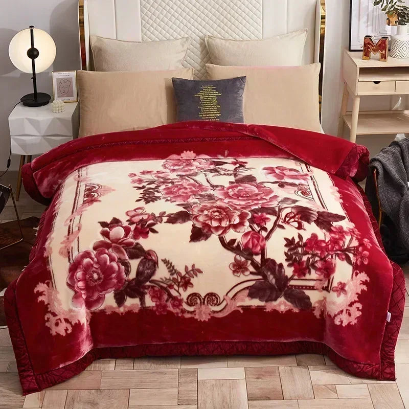 A deep red weighted plush blanket featuring a large floral pattern on the front and a lighter design on the reverse.