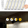 Rechargeable LED under-cabinet light fixture with a remote control and touch sensor, installed above a kitchen counter.