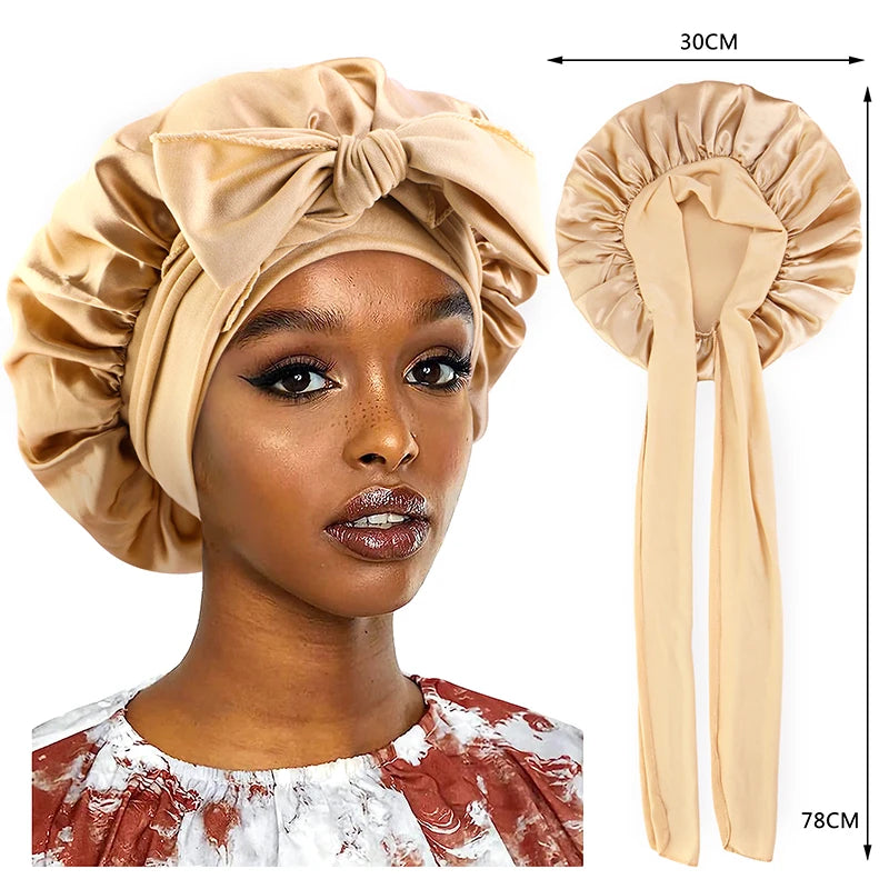 A woman models a silky satin sleep cap with a wide band in beige, shown next to the product.