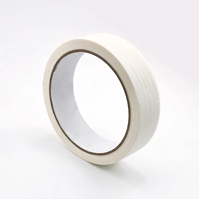 A white roll of masking tape with a clear plastic inner ring shown from the side.
