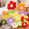 A collection of lifelike sunflower plush pillows in various colors including red, orange, yellow, purple, and green.