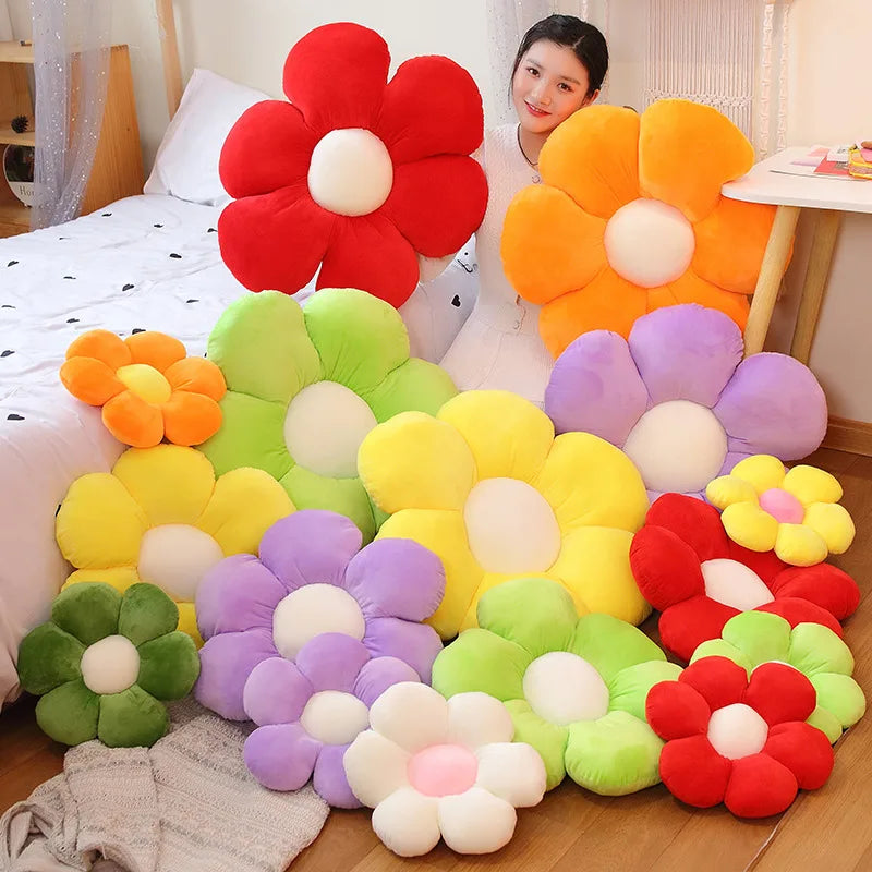 A collection of lifelike sunflower plush pillows in various colors including red, orange, yellow, purple, and green.