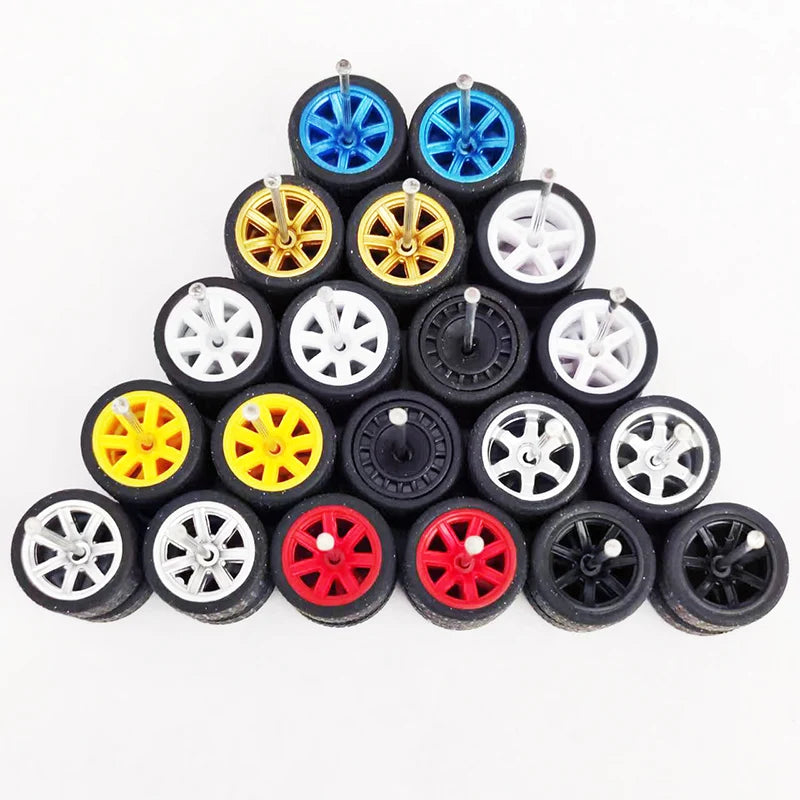A collection of 10 pairs of 1:64 scale alloy car wheels and tires in various colors including blue, yellow, silver, and red.