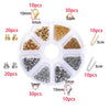 A clear plastic jewelry making kit organized into compartments containing various gold and silver beads, clasps, and jump rin