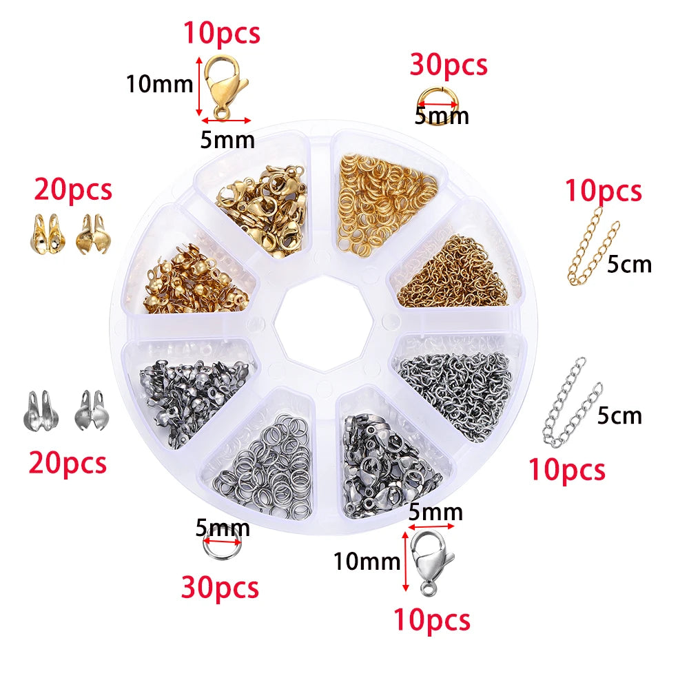 A clear plastic jewelry making kit organized into compartments containing various gold and silver beads, clasps, and jump rin