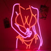 A pink neon silhouette wall sign depicting a female figure with an orange outline.