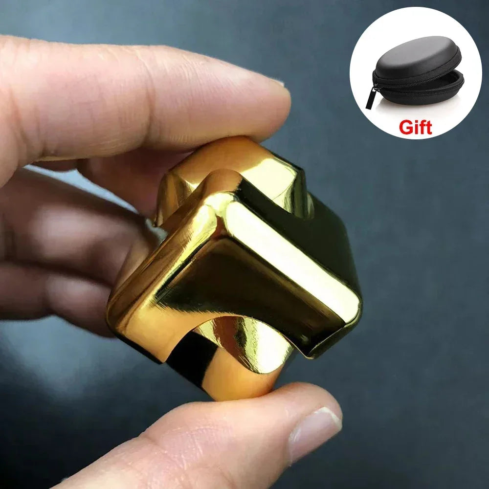 A hand holds a gold-colored alloy metal fidget cube spinner, with a black gift box visible in the upper right corner.