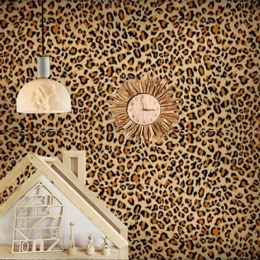 A wall decorated with leopard print wallpaper featuring a hanging light fixture and a wooden house structure.
