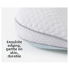 Close-up of a white quilted baby pillow showing exquisite edging and soft texture.