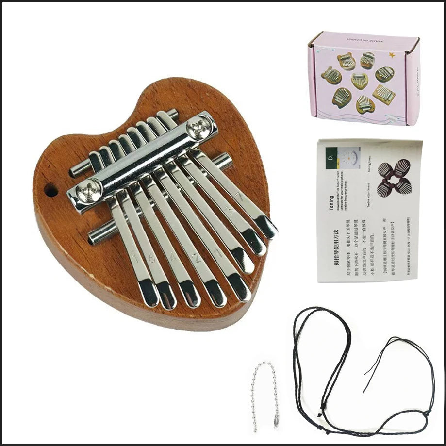 A wooden kalimba thumb piano with eight metal keys and a black cord, shown next to its packaging.