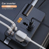A black car inverter device with a digital display showing 120 volts and various charging ports and cables.