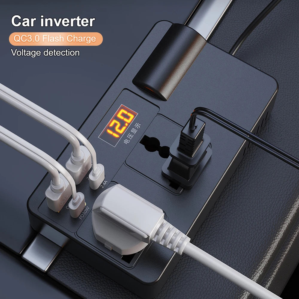 A black car inverter device with a digital display showing 120 volts and various charging ports and cables.
