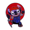 An enamel pin featuring Chucky the doll with a menacing expression set against a red background.