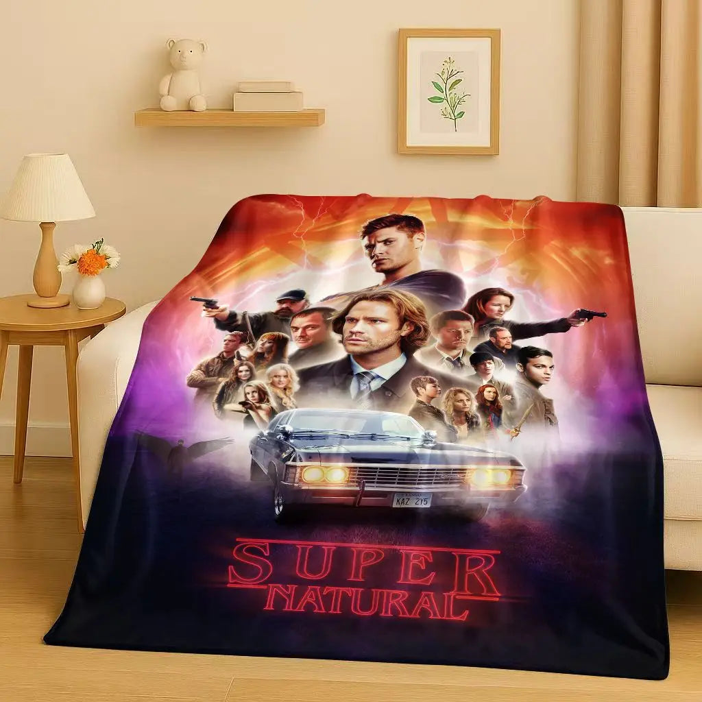 A dark blanket featuring a poster of the Supernatural TV show characters and a car.