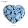 A pile of light blue silicone crown star heart beads for DIY jewelry making