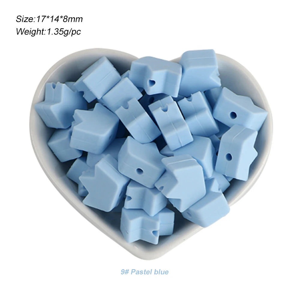 A pile of light blue silicone crown star heart beads for DIY jewelry making