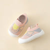 A pair of pink and yellow breathable soft-sole baby shoes with a knit upper and non-slip grip