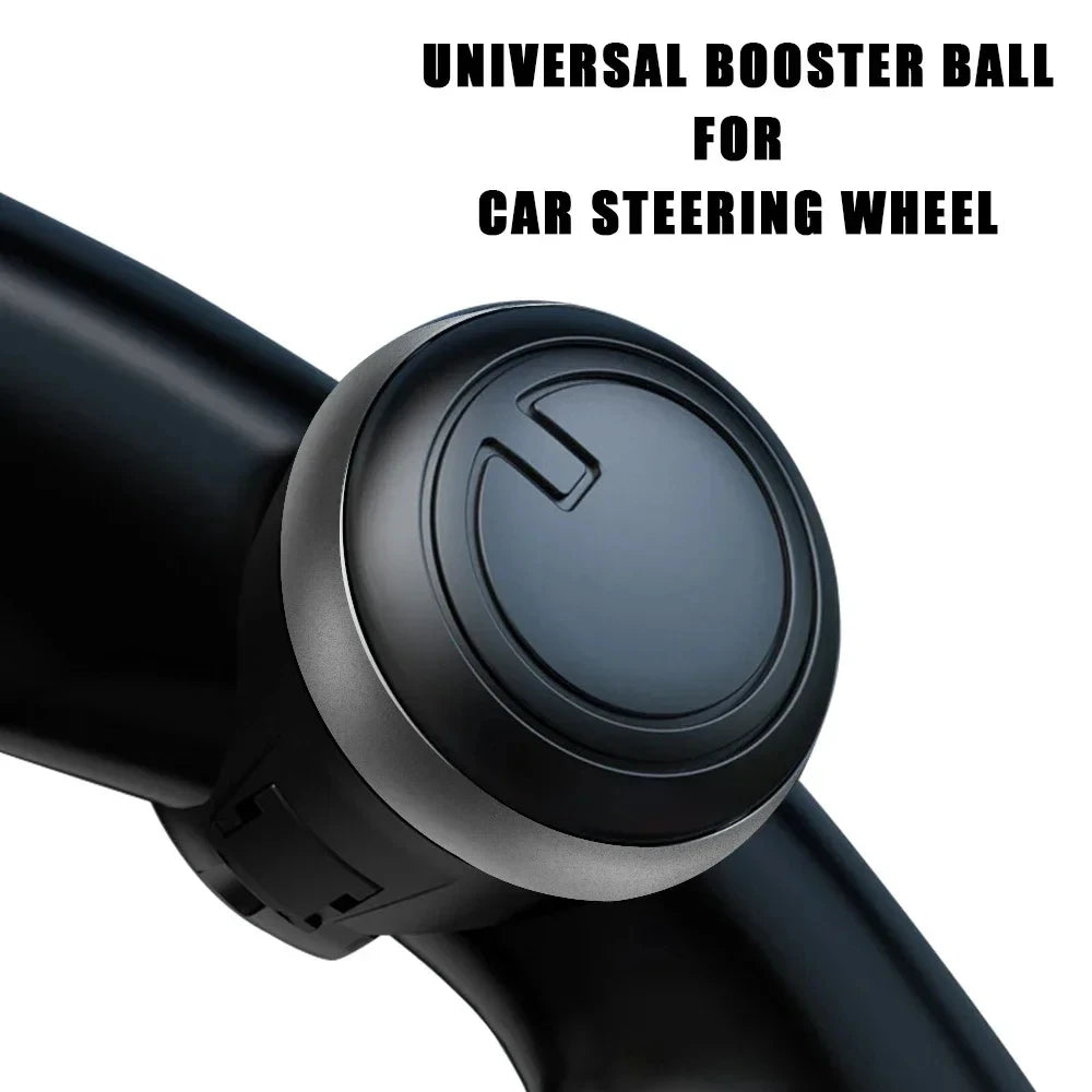 A black universal booster ball for a car steering wheel is shown in close-up.