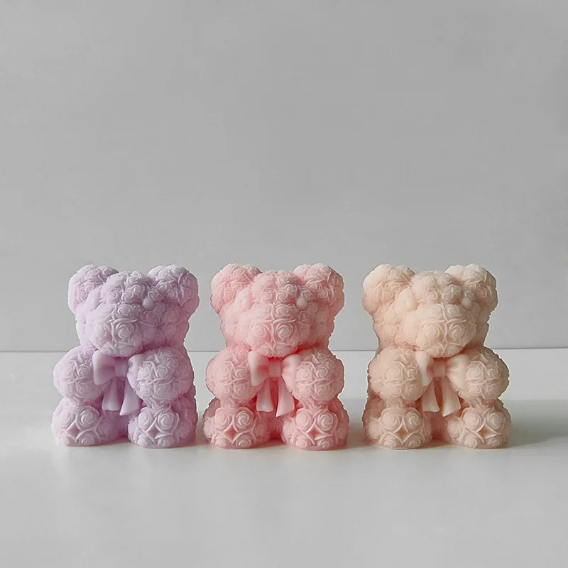 Three pink silicone bear hug molds for DIY crafts displayed on a white surface.