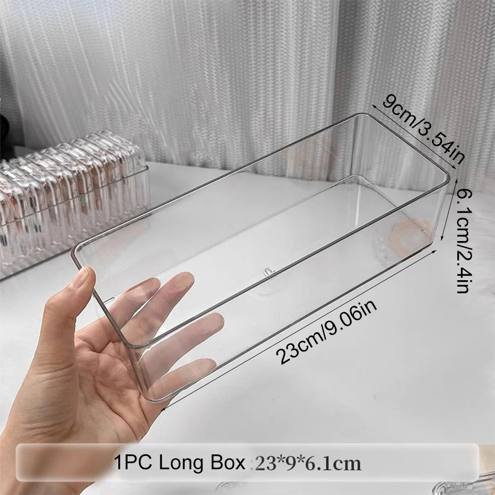 A hand holds a clear jewelry organizer box with secure compartments, showing its dimensions and design.