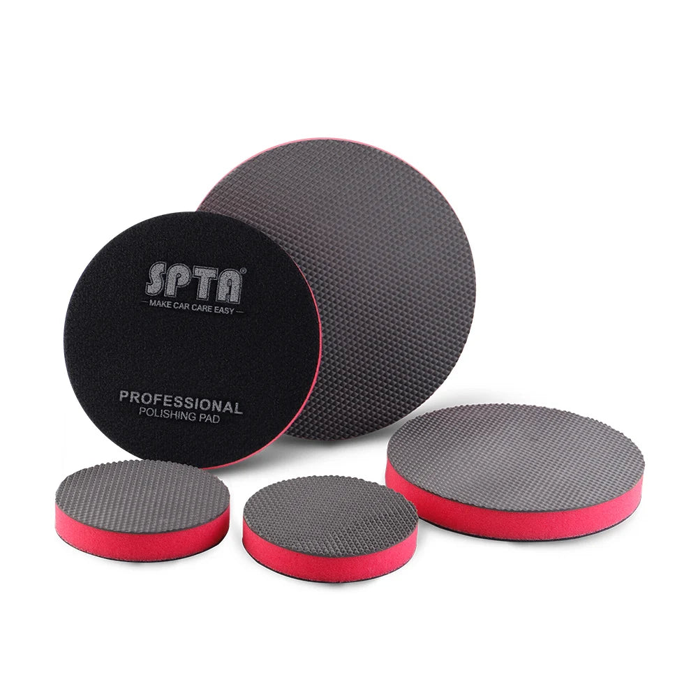 A set of three gray and red reusable car wash magic clay pads for paint detailing.