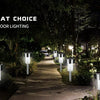 Outdoor lighting featuring modern solar powered garden lantern lights illuminating a pathway in a wooded area.