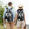 A woman wearing a light blue shirt and beige shorts is holding the hand of a man, both carrying musical icon tribute backpack