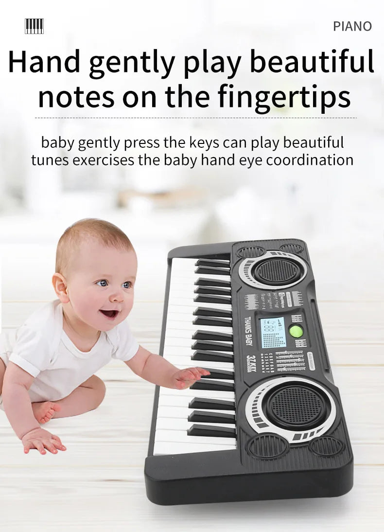 A baby is playing a small electronic piano with a microphone and LED display on a wooden surface.