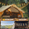 A large tent setup featuring solar-powered string lights illuminating a wooden deck and interior.