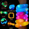 A collection of glowing LED flash pop tubes demonstrating various functions like switch button, connet, bend, twist, and stre